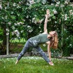 yoga pose in front of roses